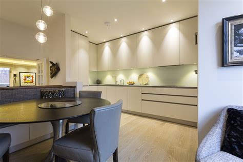 Griege Handleless Cabinets Have Been Paired With A Subtle Splashback