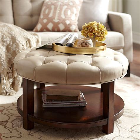 They both combine form and function like being storage devices and accent pieces in addition to serving as small tables. Liard Round Ottoman - Ivory | Leather ottoman coffee table ...