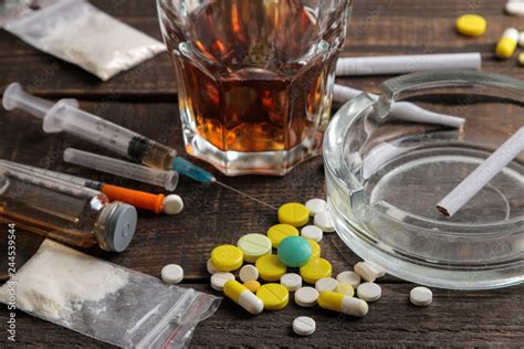 Various Addictive Drugs Including Alcohol Cigarettes And Drugs On A