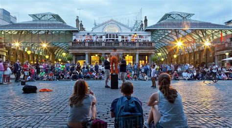 Crowd Watching Street Performers At Covent Garden London England