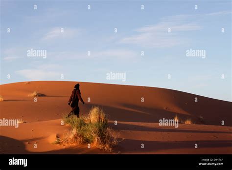 Man Walking In The Desert Stock Photo Alamy