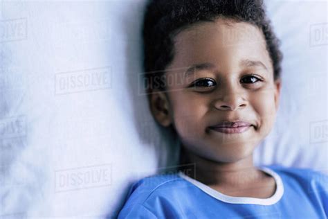 Portrait Of Smiling African American Boy Looking At Camera While Lying