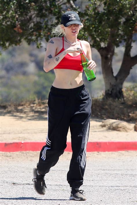 miley cyrus shows off her toned midriff in a red crop top while hiking in the hollywood hills