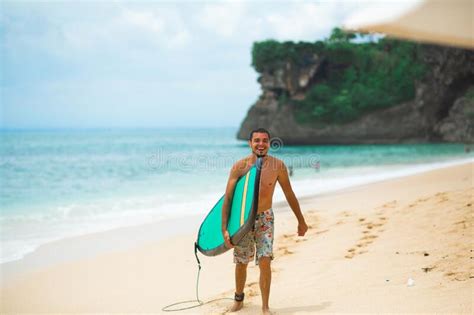 Surfer Surfing Man With Surfboard Walking On Sandy Tropical Beach