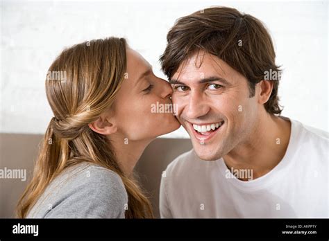 Woman Kissing Man On The Cheek Stock Photo Alamy