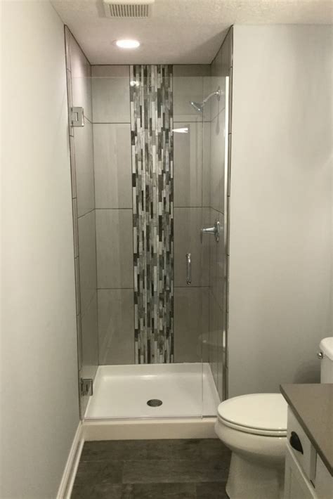 Bright white tile and a sleek glass door help to make the small shower feel larger. How to overcome your boring builders-grade white shower ...