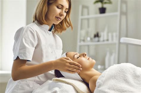 Facial Skin Care Procedures Beautician Makes A Massage Procedure With A Woman`s Face In A