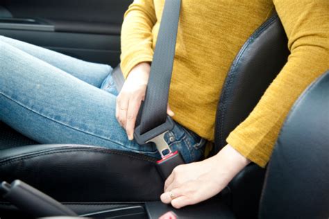 Seat belt use is the most effective way to save lives. Woman Hand Fastening A Seat Belt In The Car Stock Photo ...