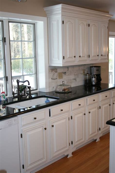 Antique white kitchen cabinets lowes. White Kitchens with Black Countertops | White cabinets ...