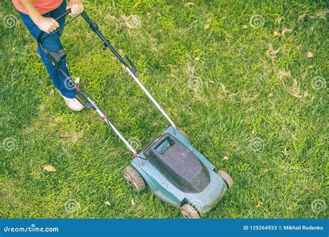 Top View Of Senior Man Using Lawn Mower On Grass Field Stock Image