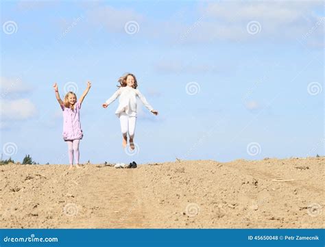 Kids Girls Jumping On Field Stock Photo Image Of Feet Cute 45650048
