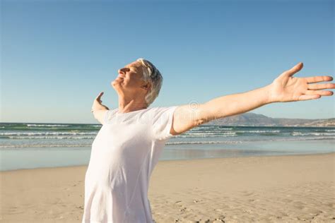 Senior Man With Arms Outstretched Standing Against Clear Sky Stock Image Image Of Senior