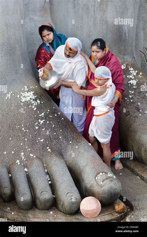 Jain Pilgrims In Front Of The Monolithic Statue Of The Jain Saint
