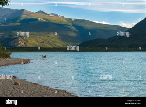 Rowing A Canoe In The Lake At Muncho Lake Provincial Park British