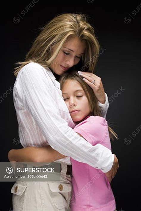 Portrait Of A Mother And Daughter Hugging Superstock