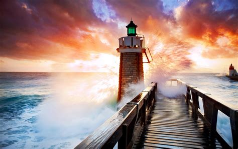Lighthouse In Stormy Sea At Sunset Hd Wallpaper