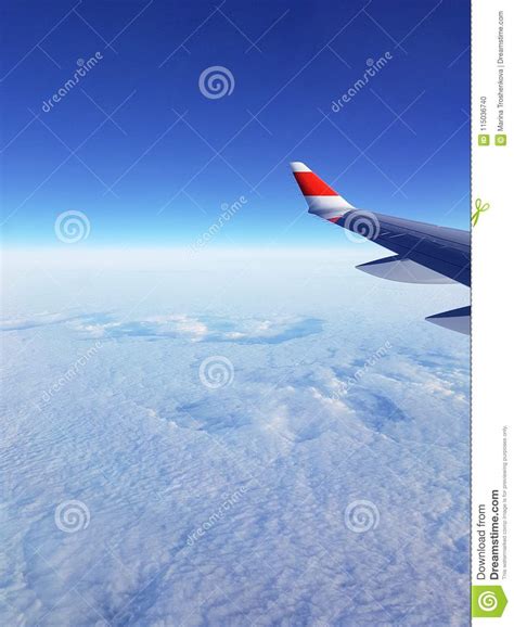 Picture Of Airplane Wing Cloudy Sky From Porthole Stock Photo Image