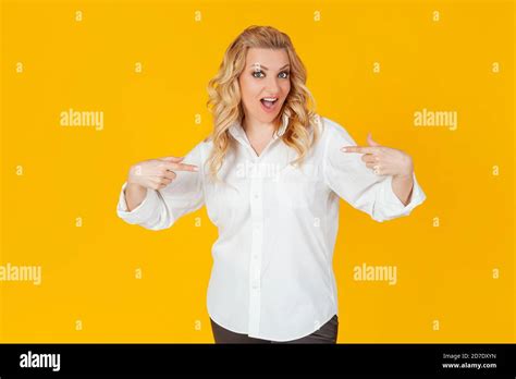 Amazed Speechless Impressed Happy European Blonde Woman In White Shirt Pointing At Herself