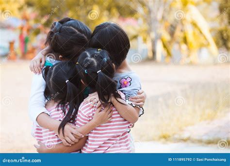 Group Of Asian Children Hugging And Playing Together Stock Photo