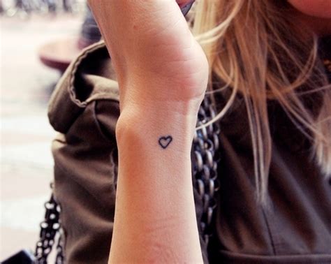 Tiny Black Heart Tattoo Outlined On Wrist