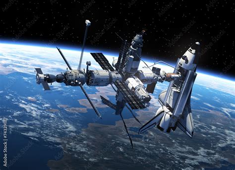 Foto Stock Space Shuttle And Space Station In Space Adobe Stock