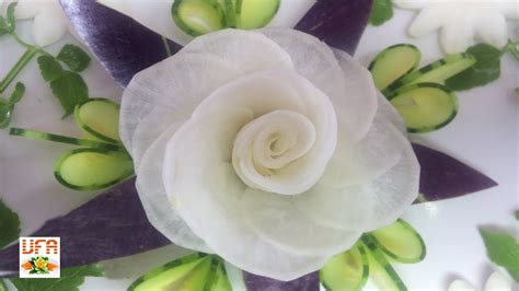 White Radish Rose Flower Sitting On Eggplant And Cucumber Carving Garnish