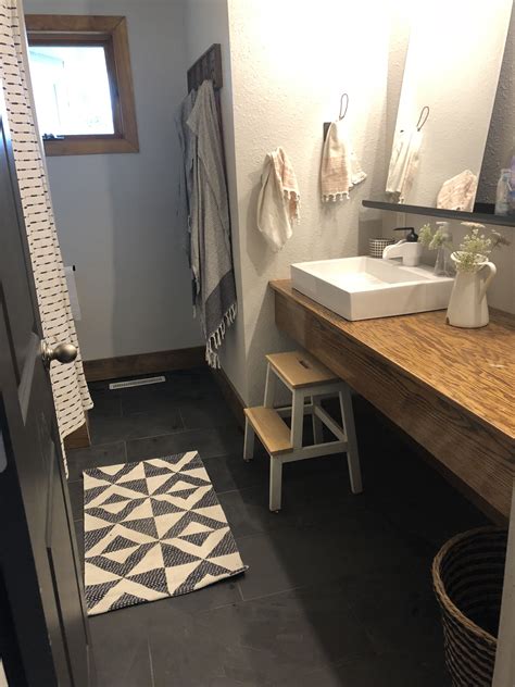 Grouting tile can be an easy task if you use the proper materials and techniques. Farmhouse mid century black tile black grout bathroom ...