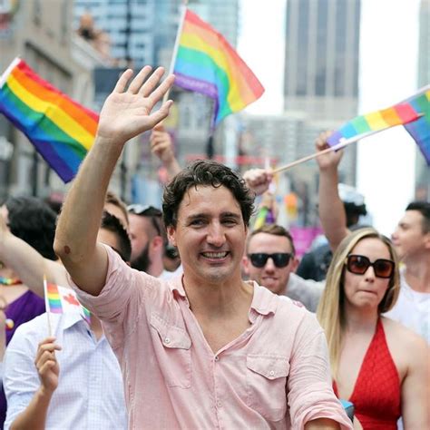 justin trudeau waving canadian maple leaf flag during toronto s gay pride parade