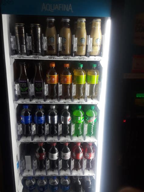 These Glass Containers Of Iced Coffee On The Top Shelf Of A Vending