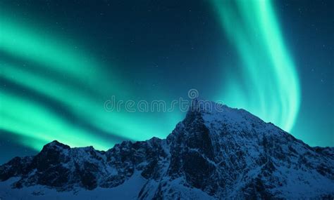 Aurora Borealis Above Snow Covered Mountain Range In Europe Stock Image