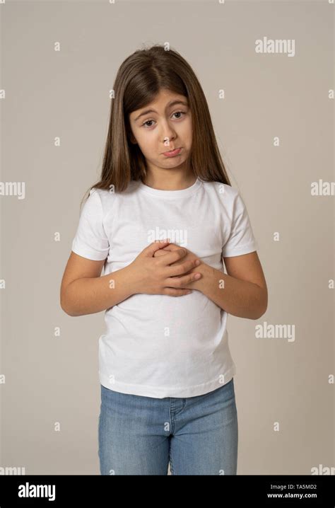 Portrait Of A Cute Young Shy Girl Looking Sorry And Timid At The Camera
