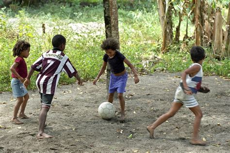 Brazilian Boys And Girls Playing Football In Tropical Heat Editorial