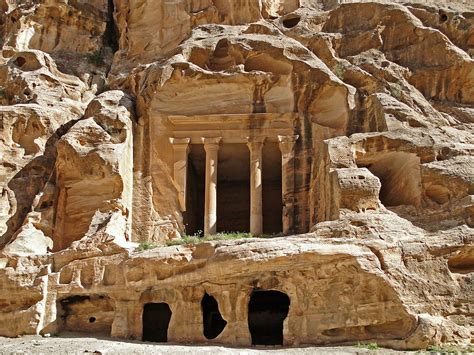 An Ancient Building Carved Into The Side Of A Mountain