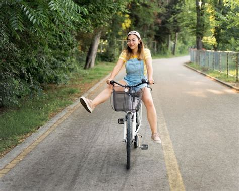 Beautiful Young Girl Riding Bike Outdoors Free Photo