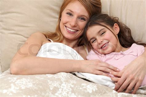 mother and daughter in bed together stock image colourbox