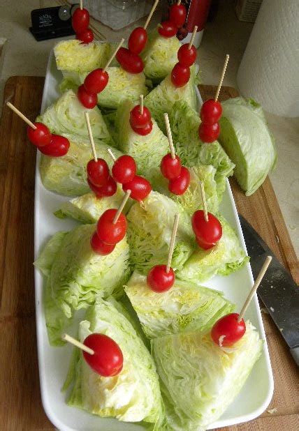 Skewer a wedge of iceberg lettuce with a stick, slide on a cherry tomato, drizzle with salad dressing and sprinkle with bit of bacon. mini WEDGE salad