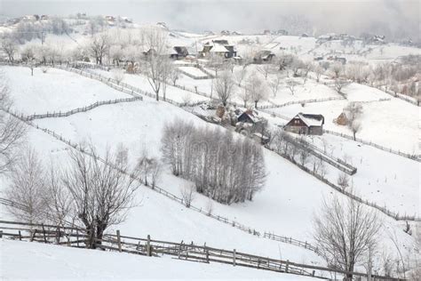 Winter In A Romanian Mountain Village With The Carpathians Stock Image