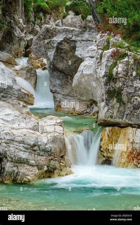 Mountain Stream Flows With Waterfalls Through Bright Gorge Val