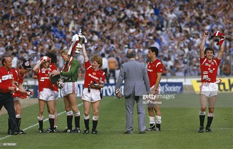 Manchester Uniteds Gordon Strachan Holds The Trophy Aloft As The