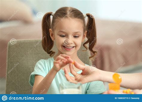 Young Mother Giving Pill To Her Daughter At Home Stock Image Image Of