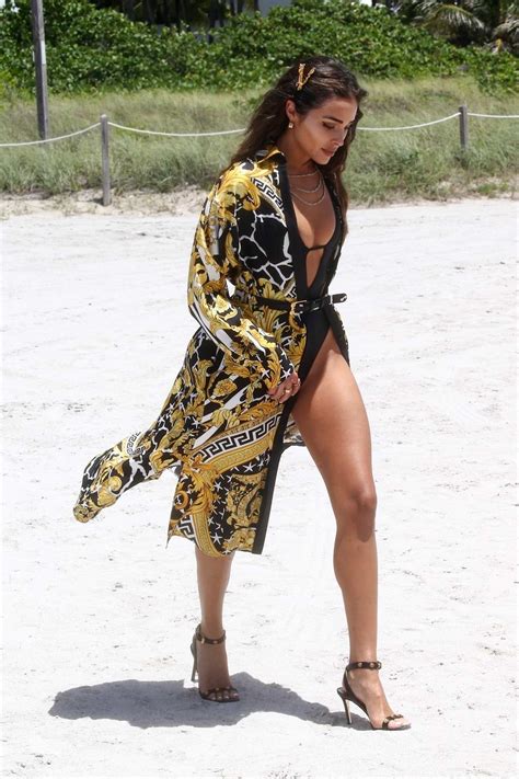 Olivia Culpo Heats Up The Beach In A Black Swimsuit While Attending A