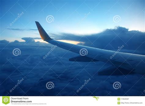 Wing Passenger Aircraft In Flight Over The Evening Clouds Stock Image