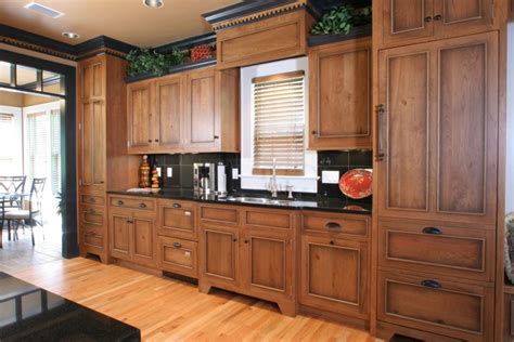 Place the hinge parts in the bucket and allow them to soak for five minutes. Refinishing Oak Kitchen Cabinets | NeilTortorella.com