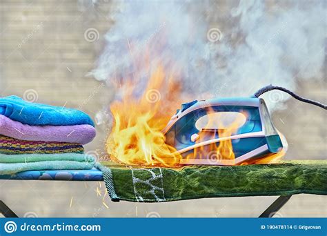 Iron For Clothes Caught Fire On An Ironing Board Stock Photography