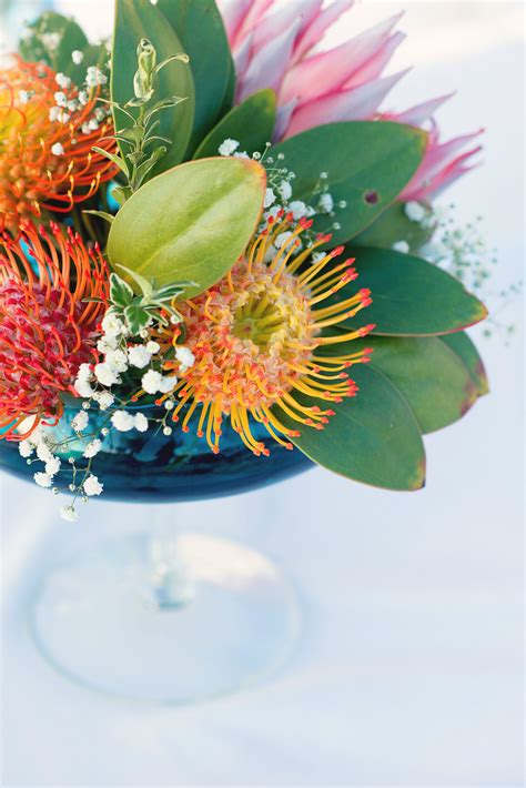 Colorful Protea Centerpiece With Babys Breath