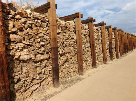 Gabion retianing wall gabion (from the italian word gabbia, which stands for cage) is an old method of building retaining walls. Gabion Rock and Timber Retaining Wall Picture | Free Photograph | Photos Public Domain