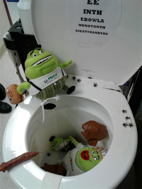 There Is A Stuffed Toy Sitting In The Toilet