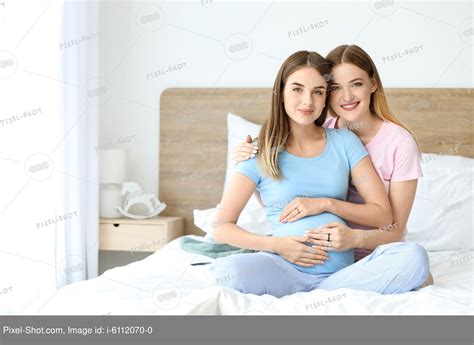 Happy Pregnant Lesbian Couple In Bedroom Stock Photography Agency