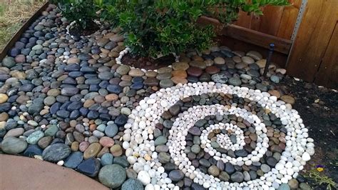 The rocks give the landscape an earthy feel and can help to minimize water usage or. Beach rock landscape swirl design | For the Home | Pinterest | Beach rocks, Landscaping and Backyard