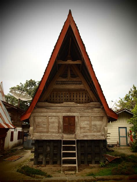 An Old Wooden House With A Red Roof